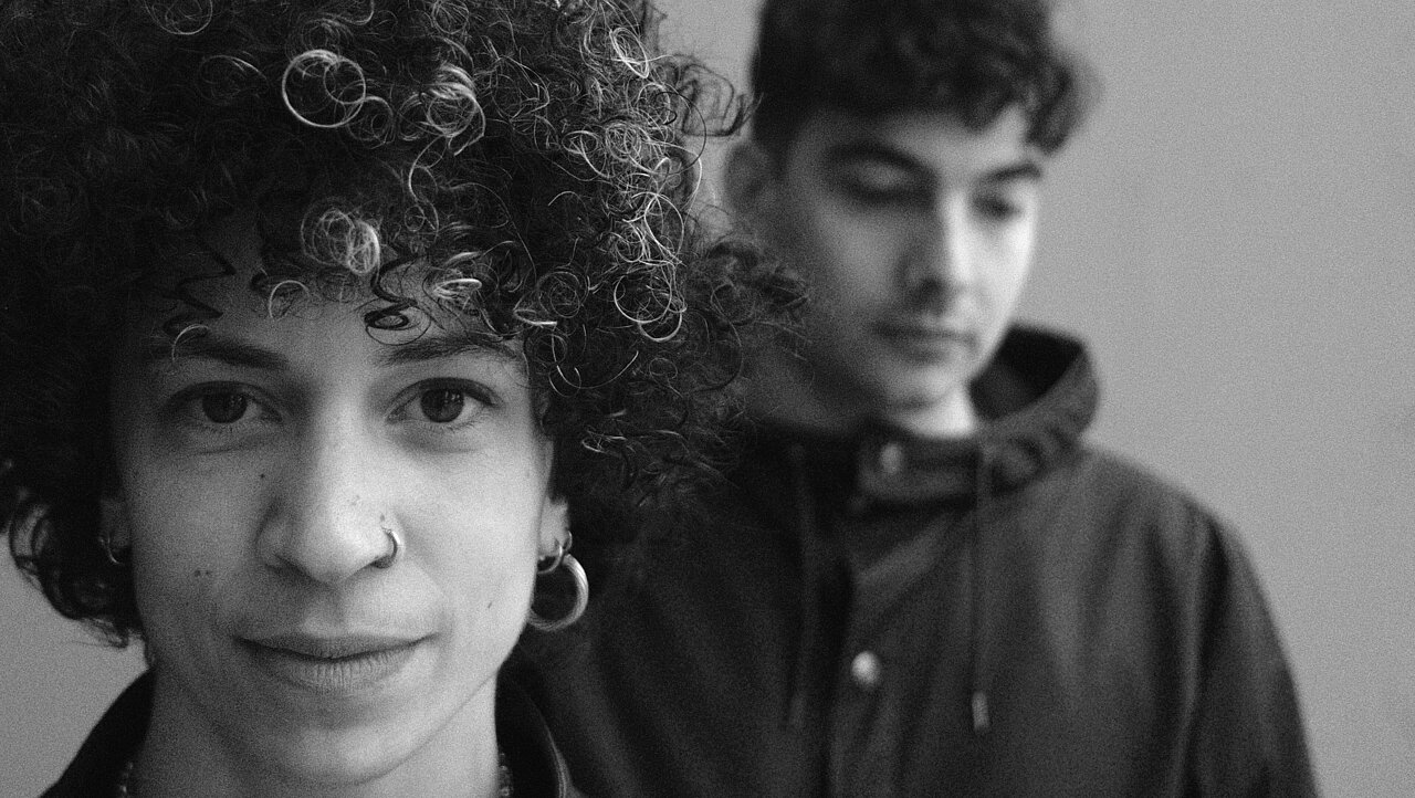 Mélissa Guex in the foreground, Clément Grin in the background, black & white portrait