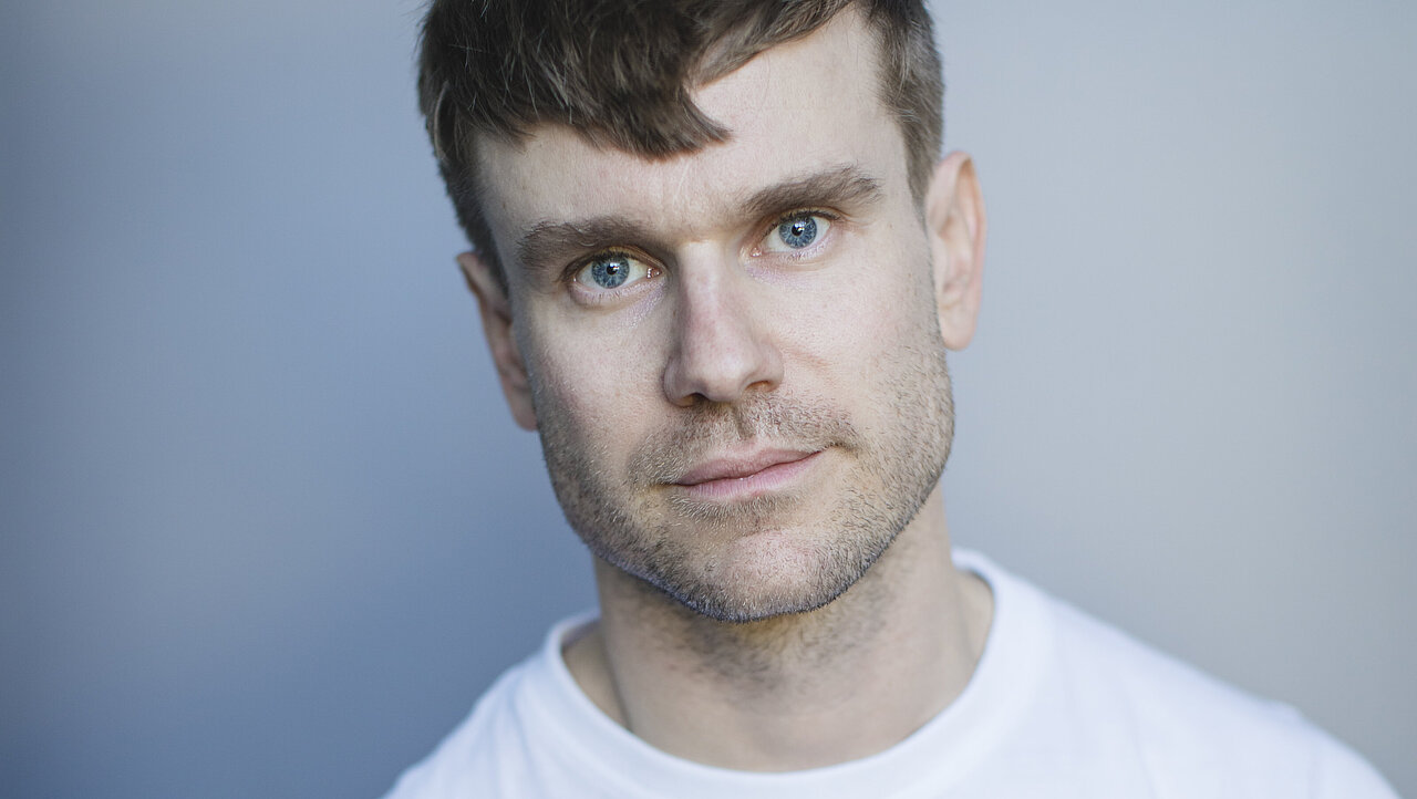 Portrait of Ole Meland, wearing a white t-shirt