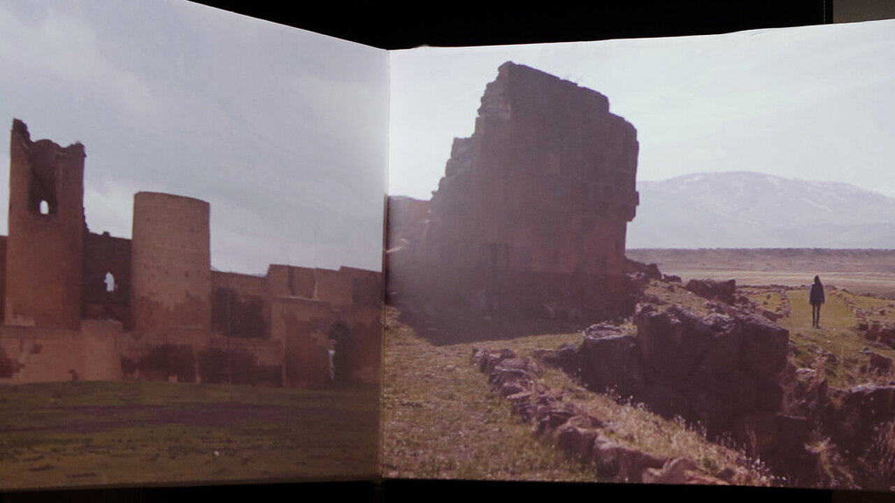 an opened book, a picture of the ruins of Ani in Eastern Turkey.