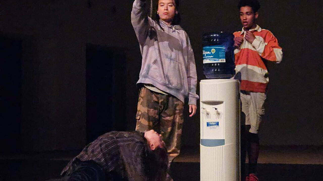 person drinking water dripping out of a bootle high above.