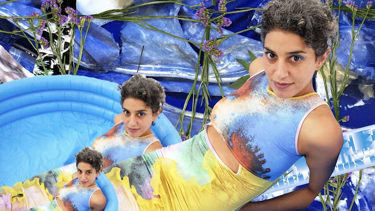 Noha in a colorful dress next to a tiny pool. 