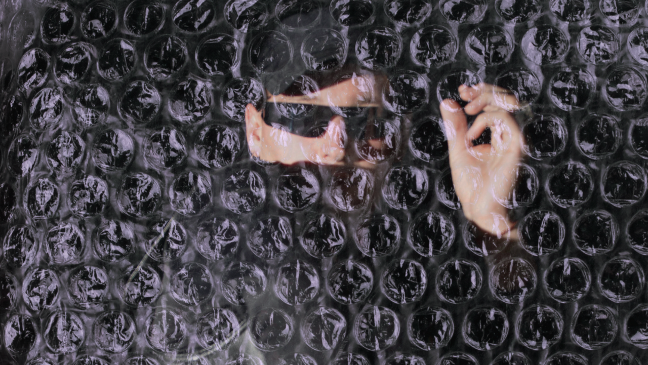performer behind bubble wrap