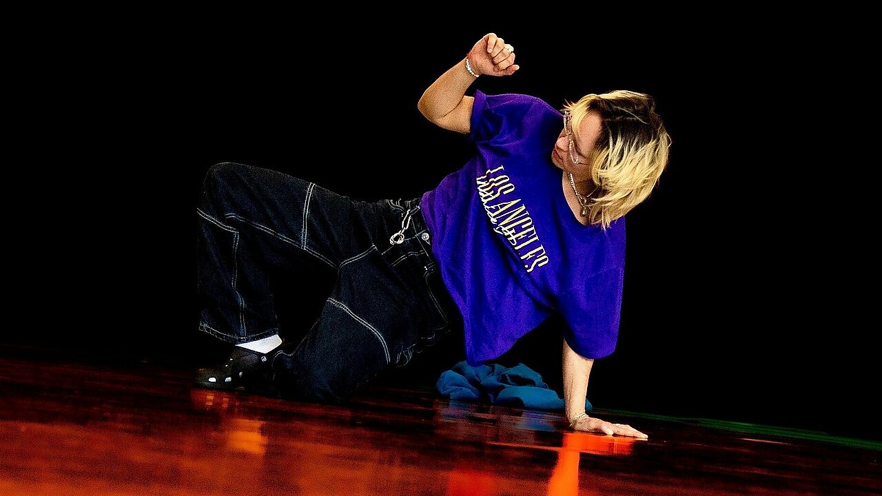 Lau on the ground, with a fist up.