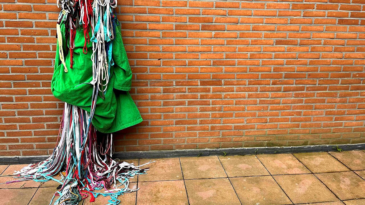 Fabrics hanging on a brick wall