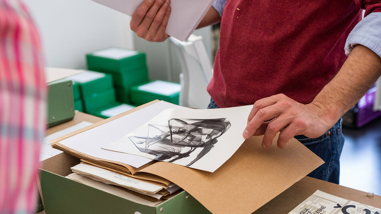 hands with a box full of photographs