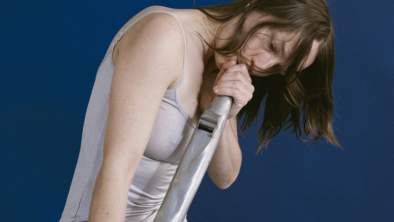 Magdalena Forster blowing into the pipe of an organ